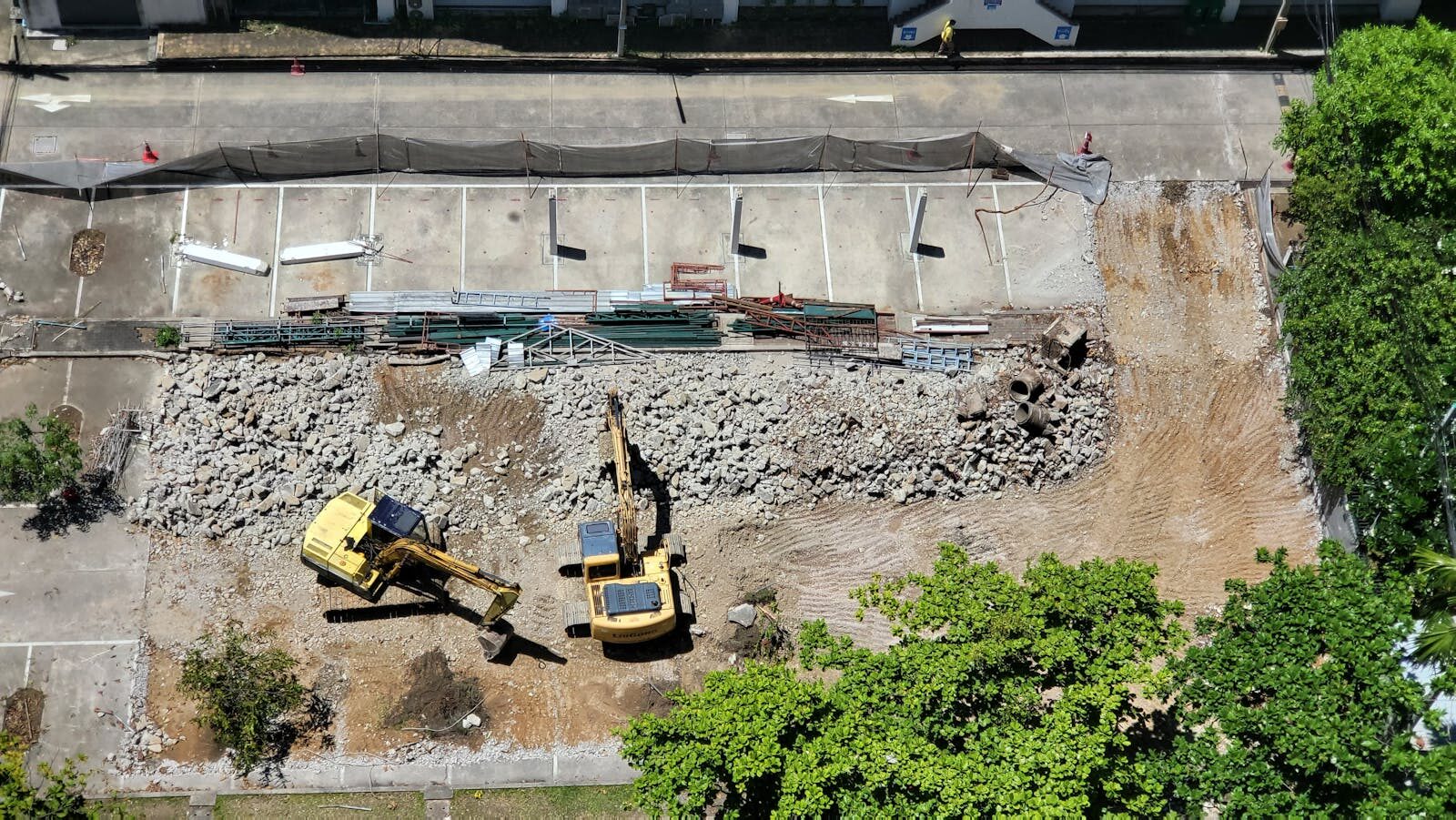 Commercial Demolition Regulations in SC & NC: Atlas Demolition project manager reviewing compliance documentation on a commercial demolition site in the Carolinas.
